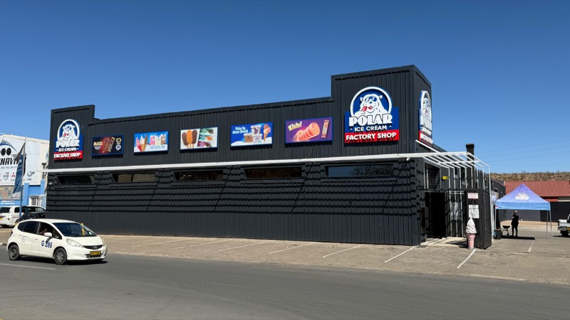 The completed Polar Ice Cream factory shop with black cladding and illuminated signage.