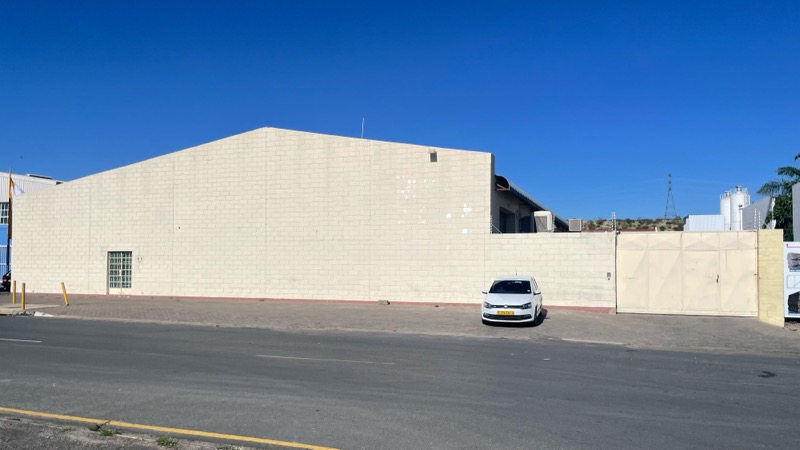 The original warehouse unit: a plain beige industrial building with a flat facade.
