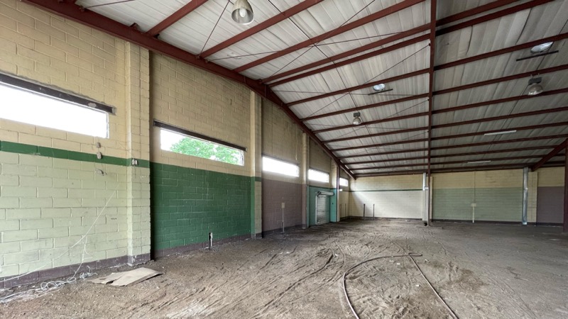 The stripped interior with a green painted band along the block walls.