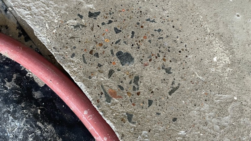 A close-up of the new slab with a service pipe cast into the concrete.