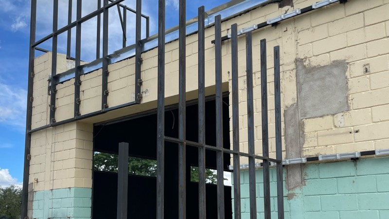 New blockwork and steel uprights framing the entrance from outside.